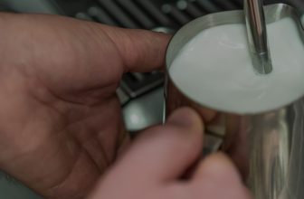 coffee machine with milk frother header